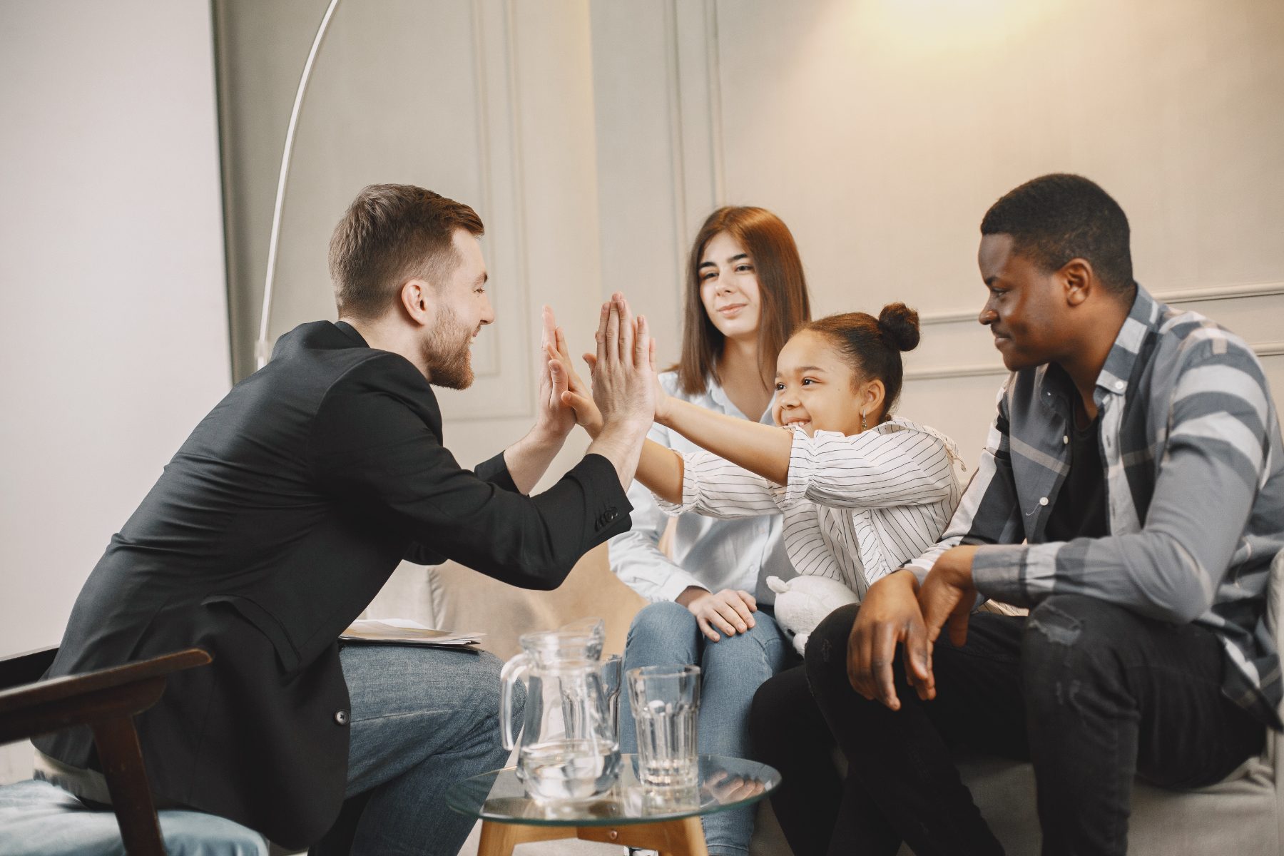 Family high-fiving their adviser